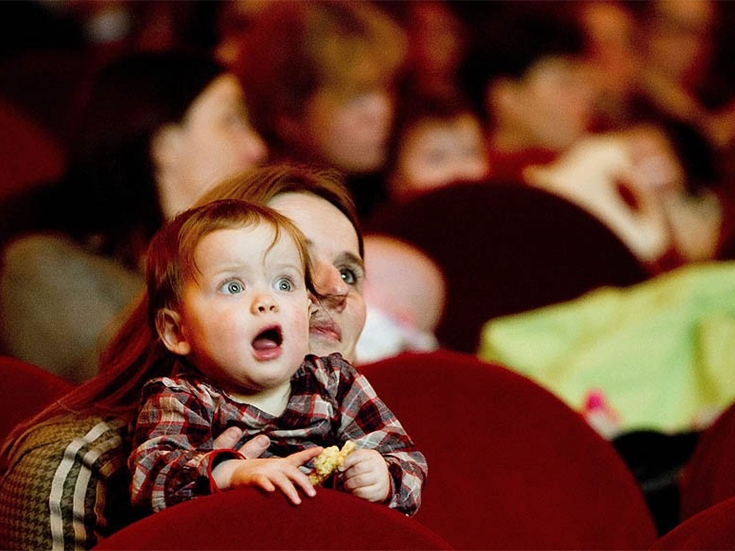 A monther and baby watching a film