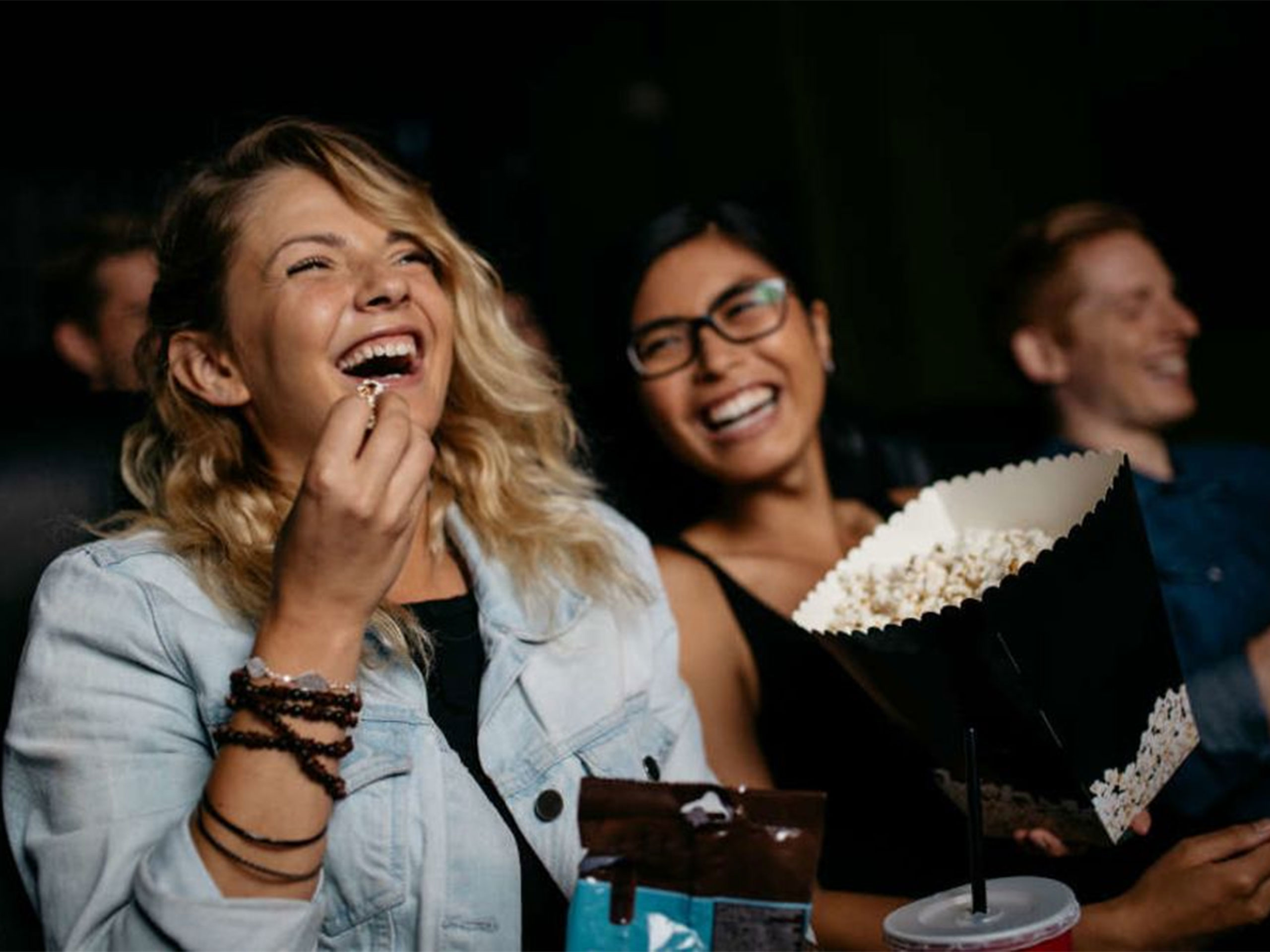 People laughing watching a film